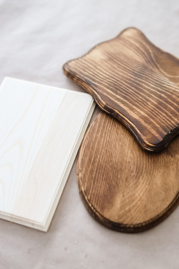 3 wood plaques, one unfinished and 2 that have been stained