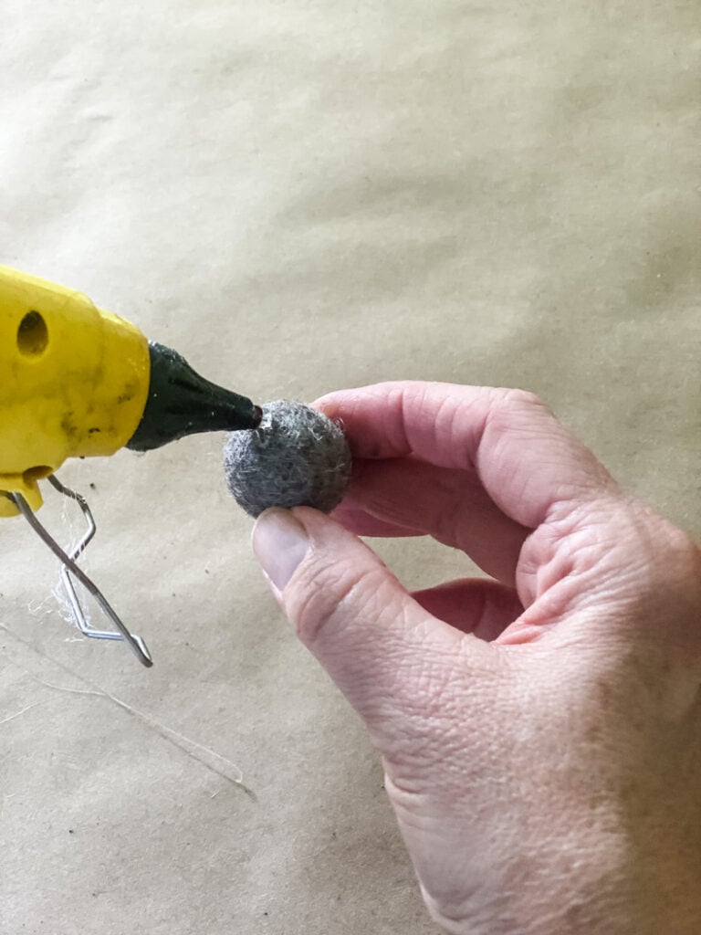 adding got glue to a felt pom pom