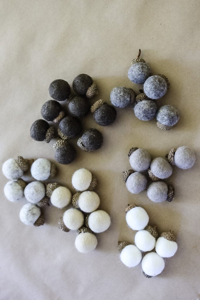 a pile of diy felt acorns