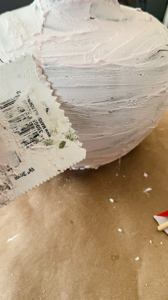 spreading joint compound over a lamp