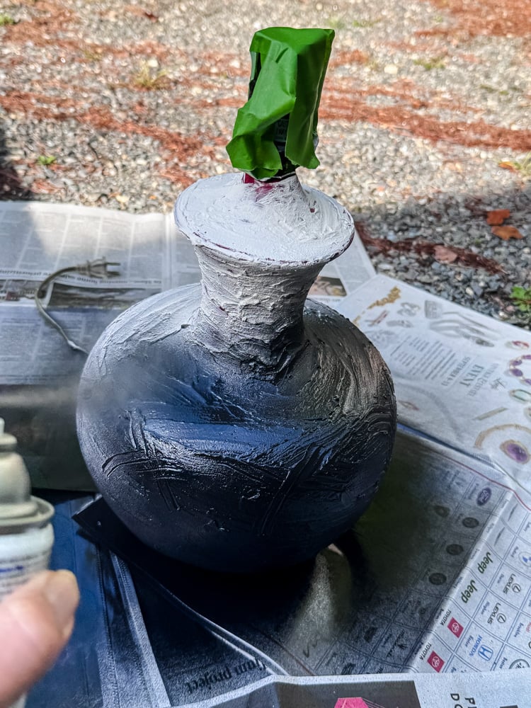 spray painting a lamp black