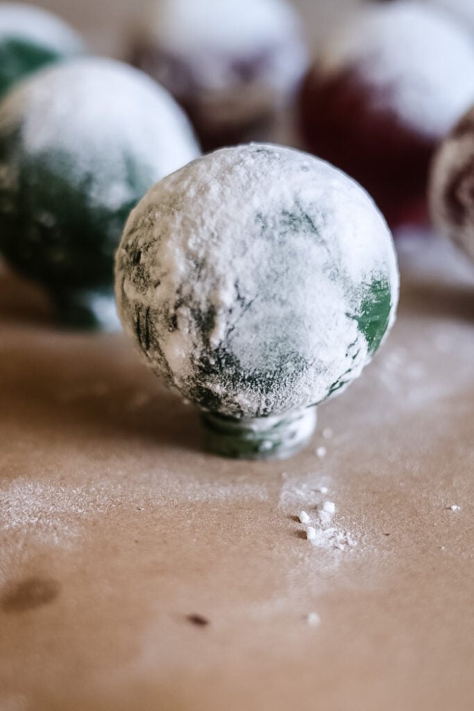 a green ornament covered in baking soda.