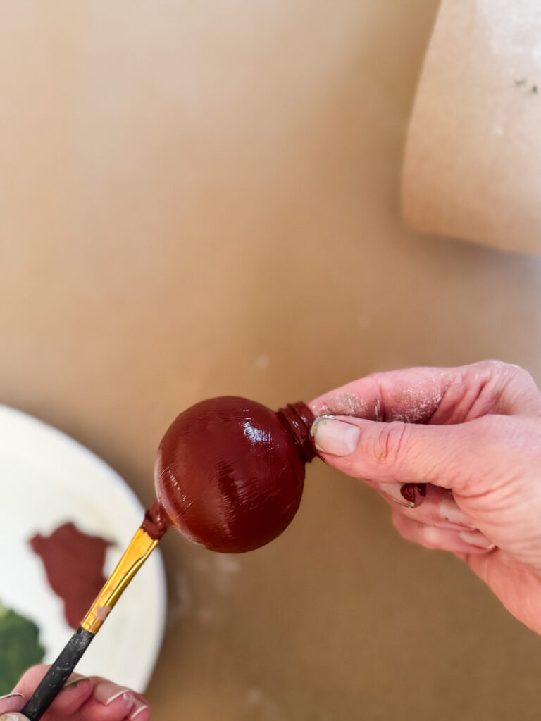 painting a clear plastic ornament red