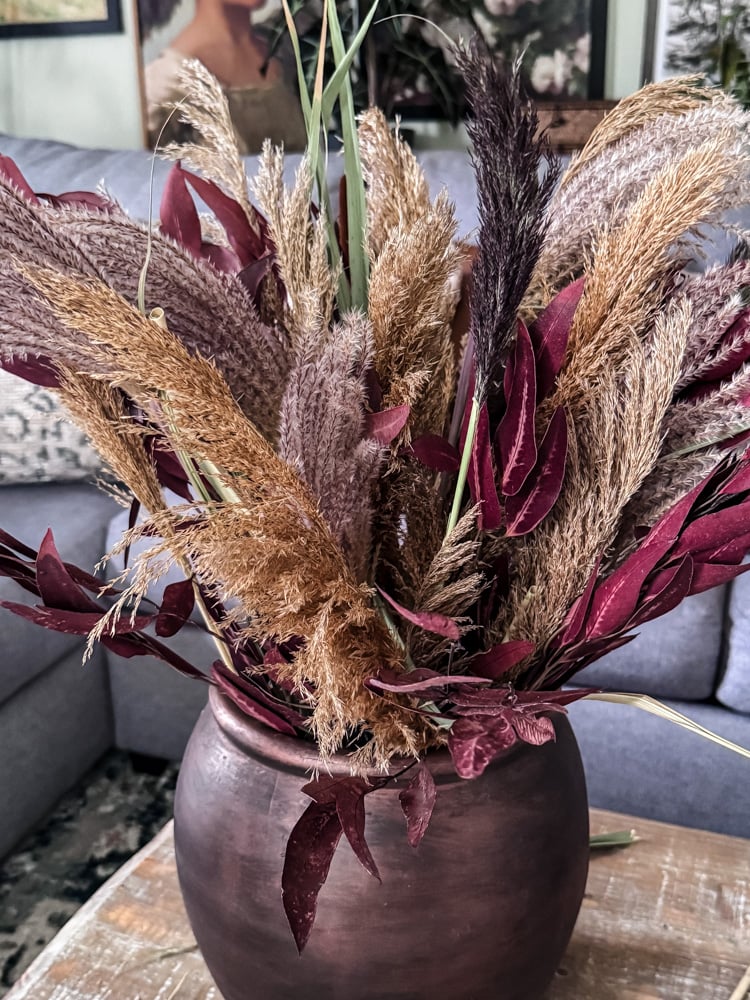 dried grasses and leaves in a vase