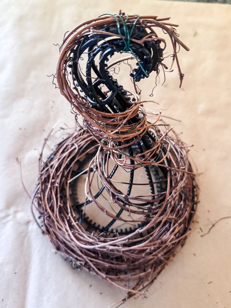 wrapping grapevine garland around witch hat