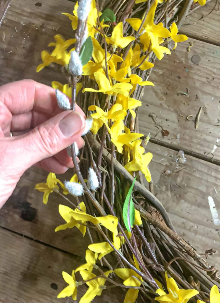 making a wreath and adding pussy willow stems