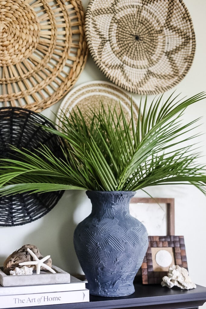 a deep blue vase on a mantle