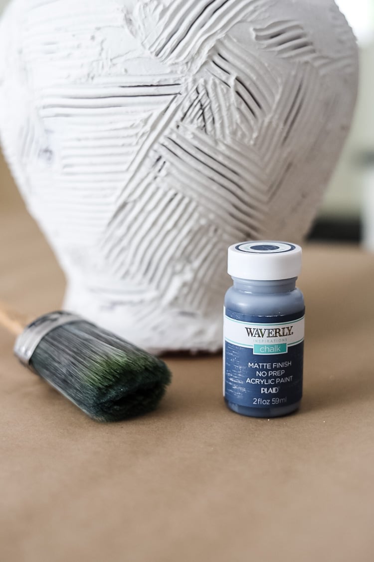 blue paint and big paintbrush