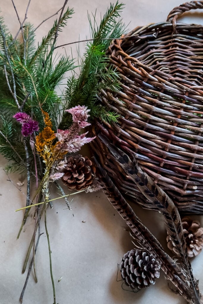 door basket, greenery, dried flowers, feathers, pinecones