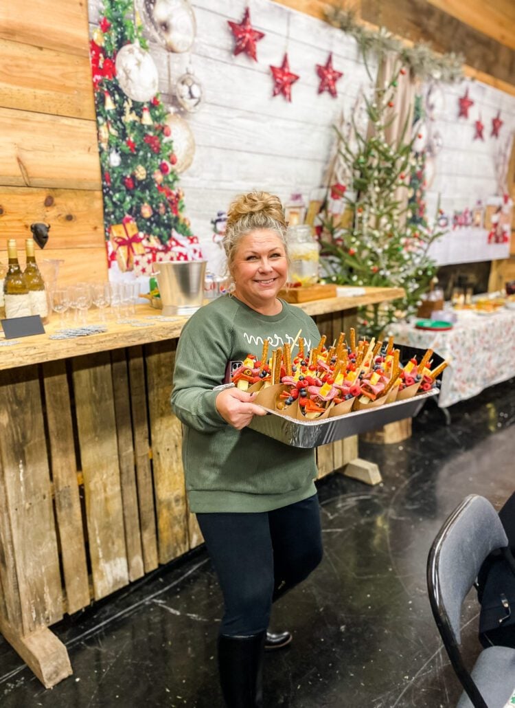 woman with tray of charcuterie cups